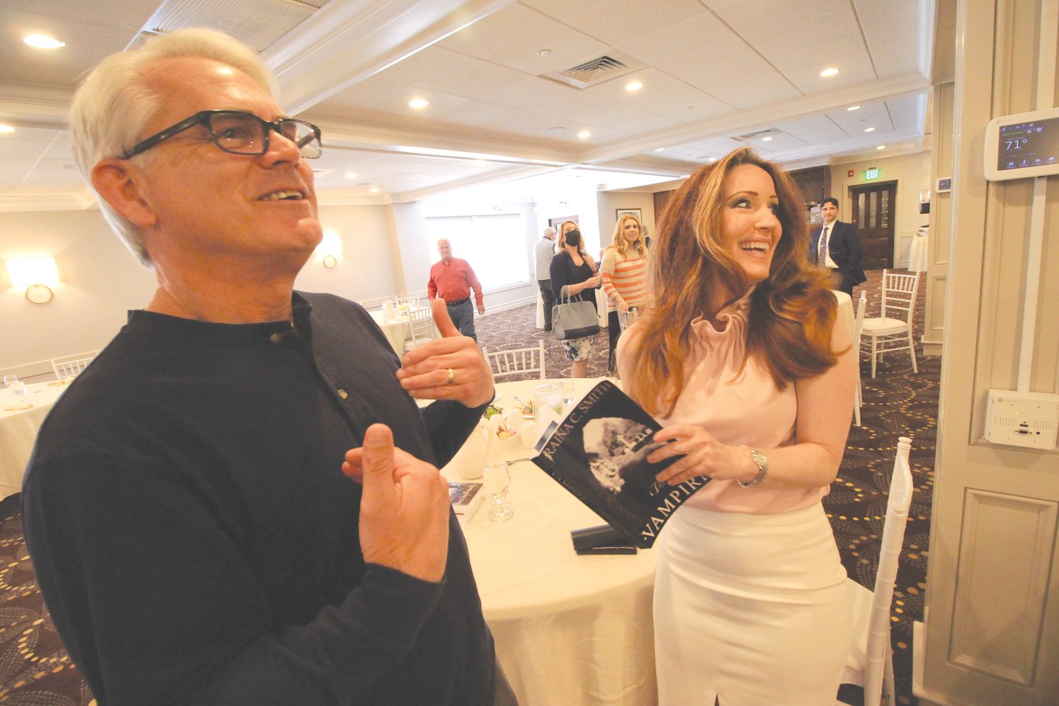 WRITER, AGENT, PUBLISHER:  Author Raina Smith and Steve Tilley, a member of the Warwick Rotary Club, exchange stories following her presentation about her books Thursday.